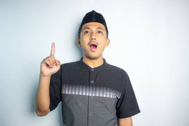 istock Smiling young Asian man wearing islamic shirt 1472189965