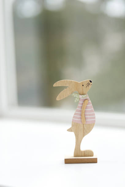 istock Handmade Easter bunny. Blurred background. Easter toys. Wooden Easter eggs on white background, copy space. 1472191023