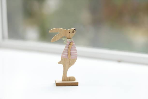 istock Handmade Easter bunny. Blurred background. Easter toys. Wooden Easter eggs on white background, copy space. 1472191726