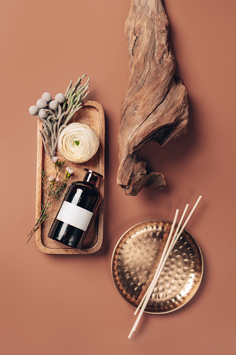 istock Scented oil for home with rattan sticks, luxury home perfume with woody and flowers fragrance. Vertical, top view photography. 1472197315