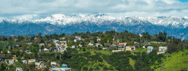 istock Los Angeles hills with snowcapped mountains in background 1472201310