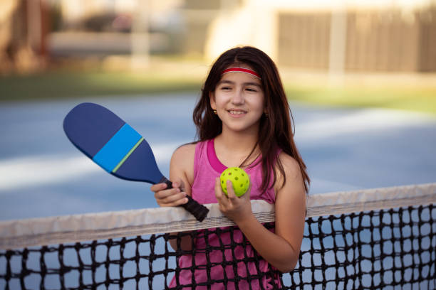istock Nine years old girl posing with a pickle ball racket 1472201644