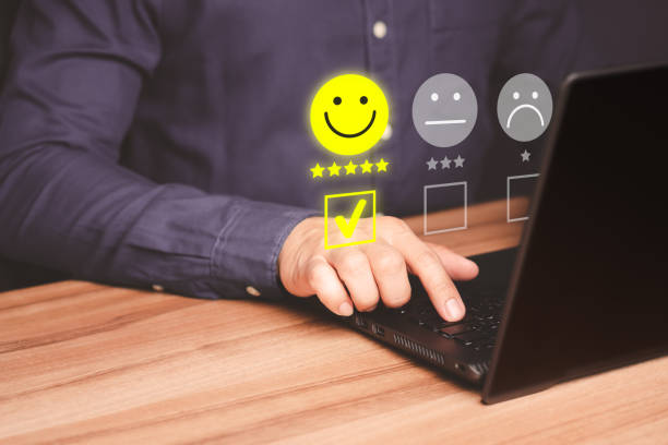 istock Man hand using computer laptop with popup five star icon for feedback review satisfaction service, testimonial. Customer service experience and business satisfaction survey. 1472202886