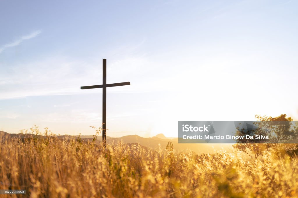 Resurrection of Jesus Christ Silhouette of a Christian cross with sunset light in the background symbolizing faith and religion or resurrection of Jesus Christ Religious Cross Stock Photo