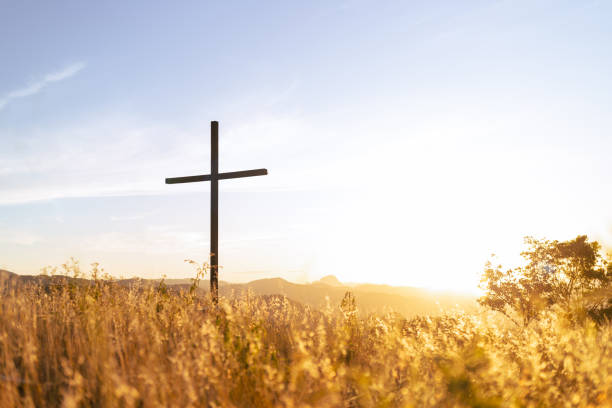 Resurrection of Jesus Christ Silhouette of a Christian cross with sunset light in the background symbolizing faith and religion or resurrection of Jesus Christ religious cross stock pictures, royalty-free photos & images
