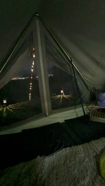istock Inside-outside view from luxurious tent in the tropics at night 1472206794