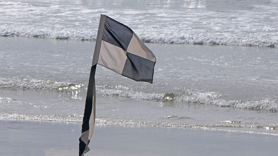 Beach Warning Flags to indicate sea hazard on a sandy beach