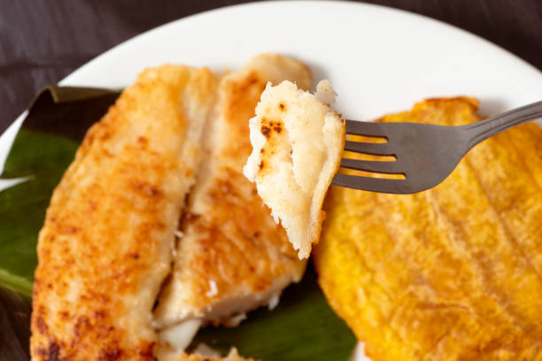 istock Fork splitting a piece of fish fillet 1472214016