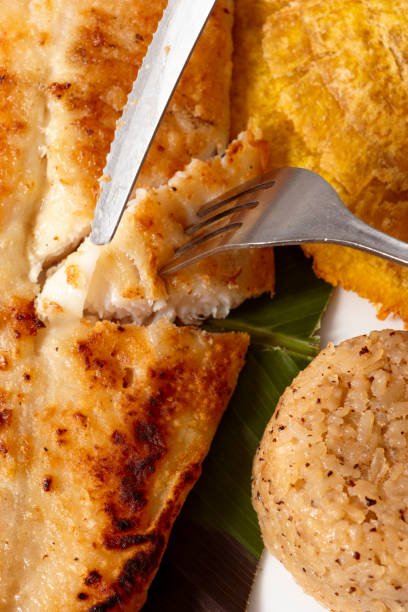 istock Fork splitting a piece of fish fillet 1472214021