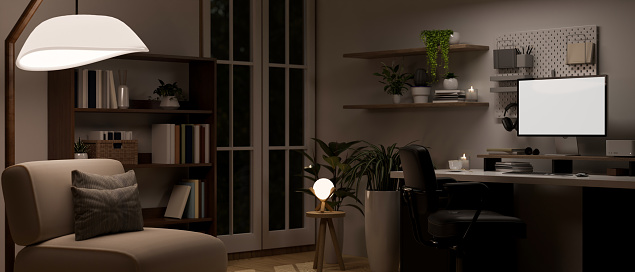 Modern contemporary dark home office interior design with computer white screen mockup, stylish lamp, armchair, indoor plants and home decor. 3d render, 3d illustration