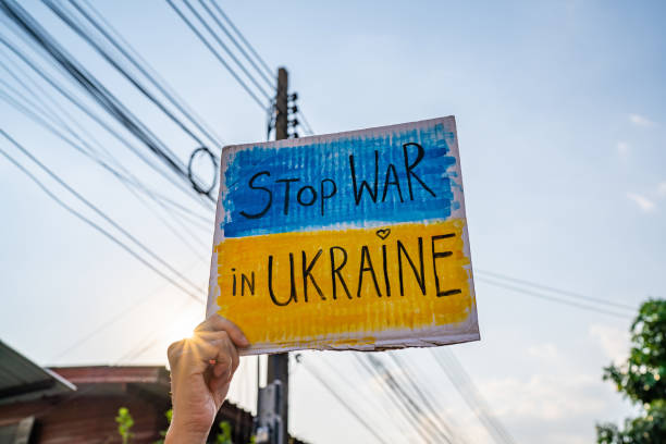 istock Protester holding a placard about stopping the war in Ukraine 1472219680