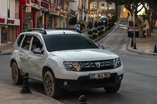 Side, Turkey – February 13 2023:  white Mercedes-Benz  X-Class   is parked  on the street on a warm summer day against the backdrop of a buildung, trees
