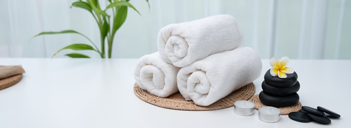 Spa accessory composition set in day spa hotel , beauty wellness center . Spa product are placed in luxury spa resort room , ready for massage therapy from professional service .