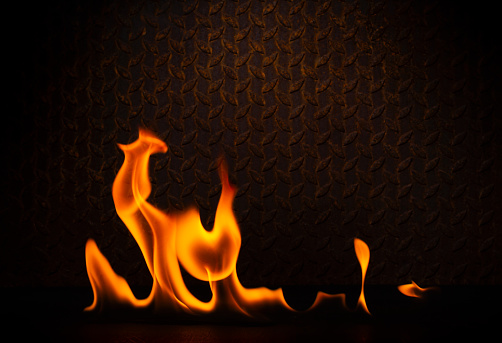 fuel flame png heat and danger of burning bbq explosion yellow-red flame isolated on rusty black steel plate background