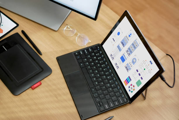 istock ux ui design on desktop and laptop computer screen working at home.mobile app interface design 1472236487