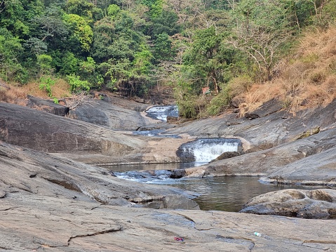 Long view of Kozhippara waterfalls in Kakkadampoyil, Calicut, Kerala, India.