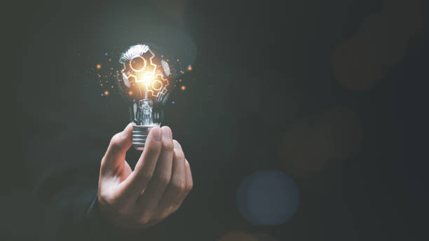 istock solution concept and demonstrating leadership strategies ,ideas ,thought process ,innovation and brain power from brainstorming ,A light bulb representing the power of thought in the human hand 1472239139