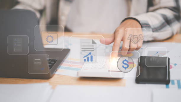 istock small entrepreneurs calculating figures in company financial documents with a calculator,analysis of company financial data,Planning to assess and review budgets,concept of finance and investment 1472239141