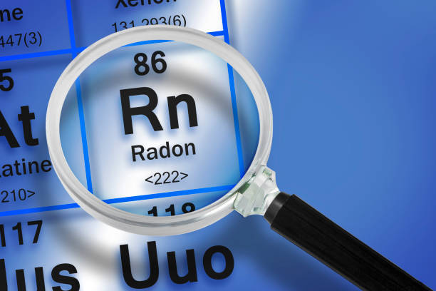 istock Focus on Radon gas chemical element from the Mendeleev periodic table - concept with magnifying glass 1472240167