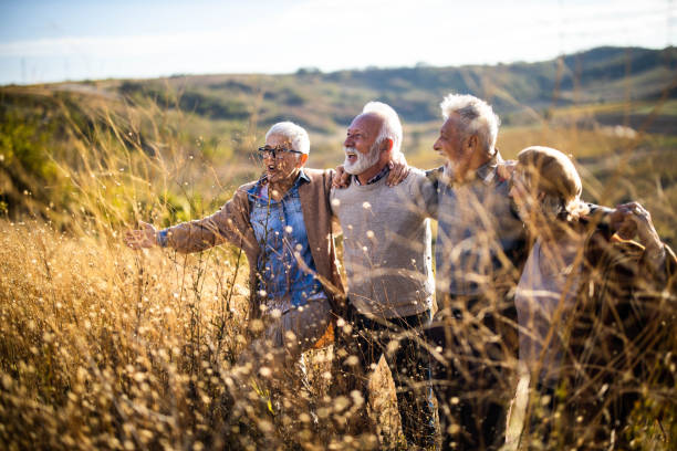 istock Happy senior couples walking embraced up the hill. 1472240244