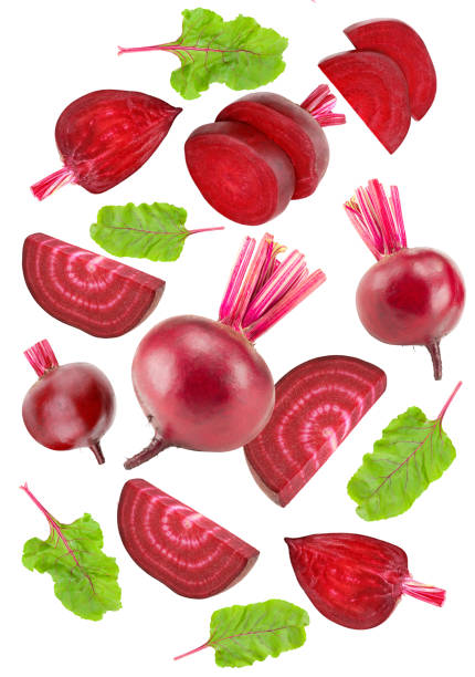 istock flying beetroot with pieces of beetroot and green leaf isolated on white background. clipping path 1472240779