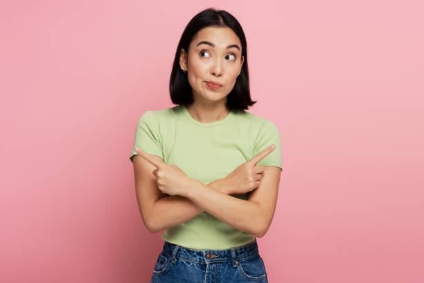 istock Serious confident bossy woman pointing fingers, making choice, thinking 1472243035