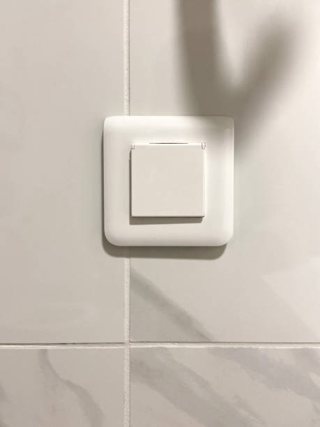 istock Electric light switch on the tile wall in bathroom or kitchen 1472246793