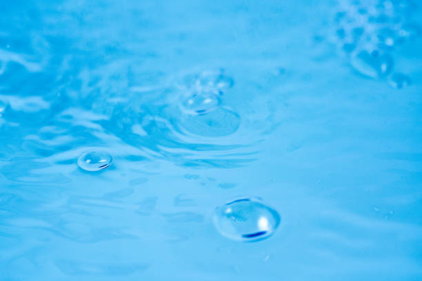 Close-up of a water drop falling into the water
