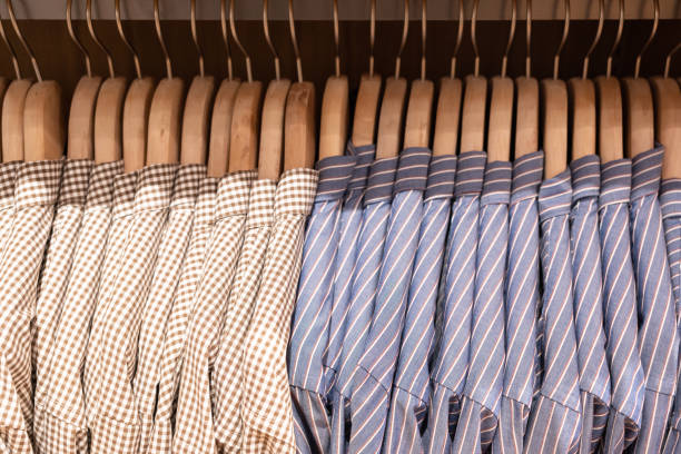 ropa o pantalones de muchos colores cuelgan en un estante en una tienda de ropa de diseño. - department store suit mannequin clothing fotografías e imágenes de stock