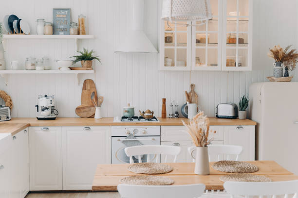 istock Scandinavian kitchen design. Modern dining room decoration. White luxurious interior and appliance. 1472249204