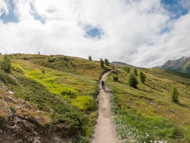 istock Man mountain biker rides along trail in Summer 1472249761