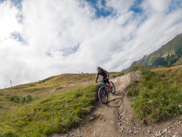 istock Man mountain biker rides along trail in Summer 1472249831