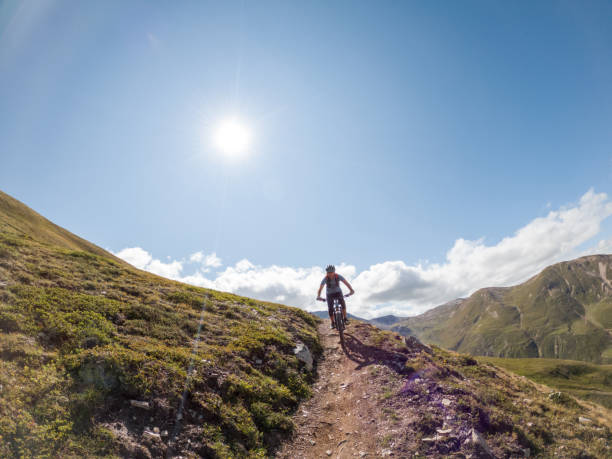 istock Man mountain biker rides along trail in Summer 1472252377