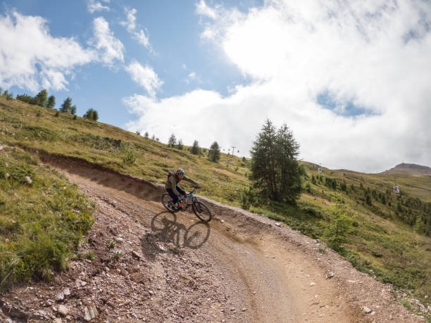 istock Man mountain biker rides along trail in Summer 1472253527