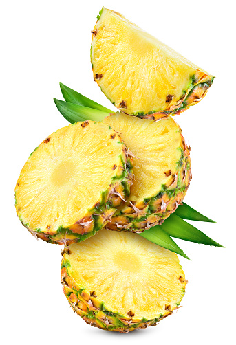 Pineapples isolated. Pineapple slices with leaves flying on white background. Cut pineapple with round slices are falling. Full depth of field. Composition isolate on white.