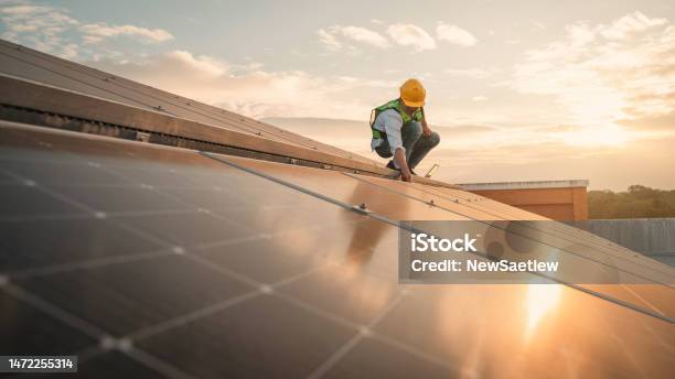 Service Engineer Checking Solar Cell On The Roof For Maintenance If There Is A Damaged Part Engineer Worker Install Solar Panel Clean Energy Concept Stock Photo - Download Image Now