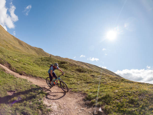 istock Man mountain biker rides along trail in Summer 1472256264