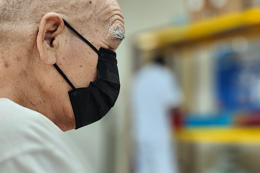 An Asian senior man is at hospital for annual medical check-up