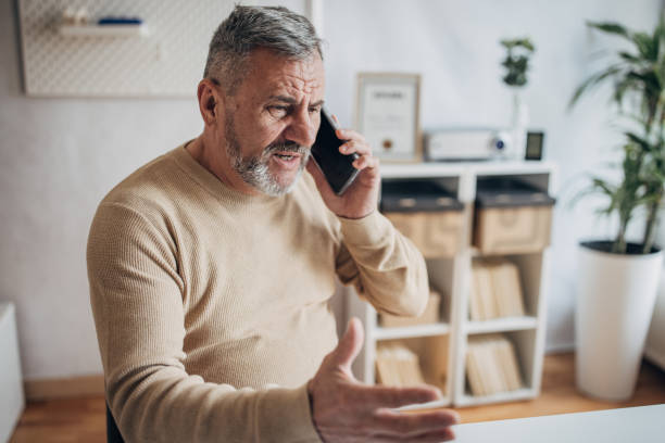 istock Bad news for a businessman with a beard, using a mobile phone 1472256785