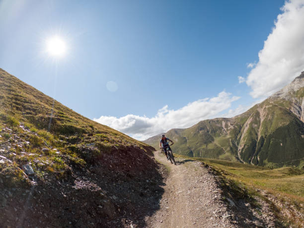 istock Man mountain biker rides along trail in Summer 1472257009