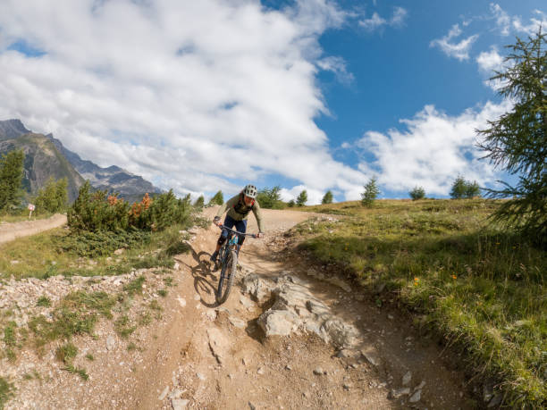 istock Man mountain biker rides along trail in Summer 1472257197