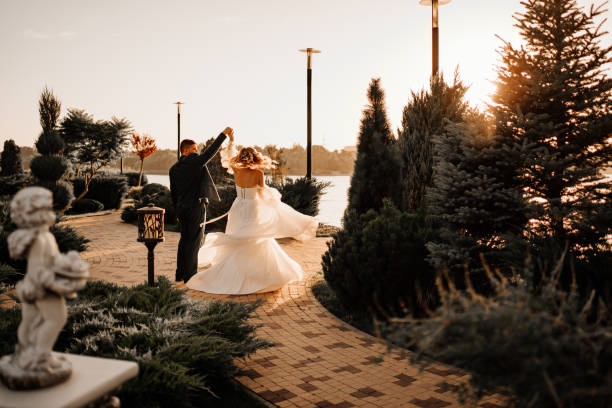 istock dancing happy bride and groom in nature. at sunset 1472258185