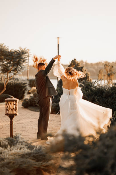 istock dancing happy bride and groom in nature. at sunset 1472258227