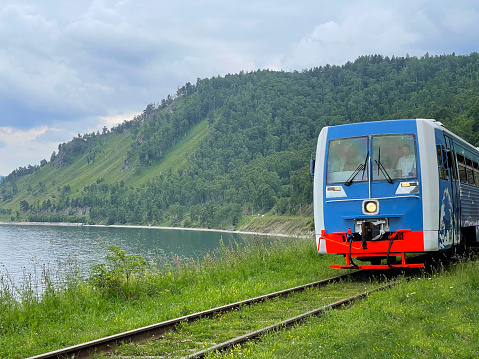 15 of July 2022 - Port Baikal, Russia: Train on arailway along the Lake Baikal, Russia