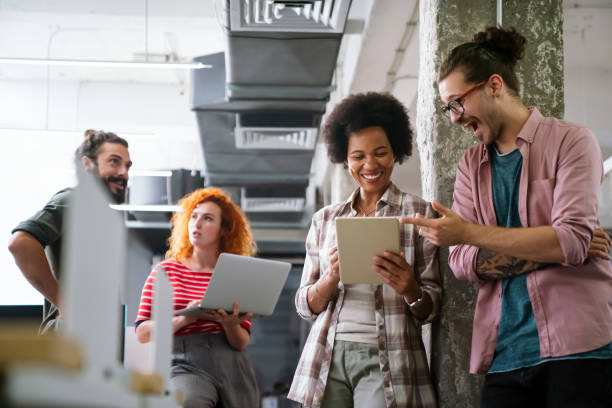istock Smiling diverse colleagues gather in boardroom brainstorm discuss financial statistics together 1472259519
