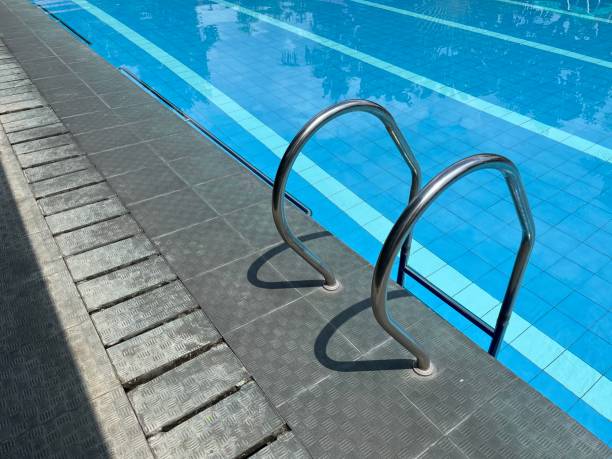 istock Swimming pool with metal stairs handle 1472260055
