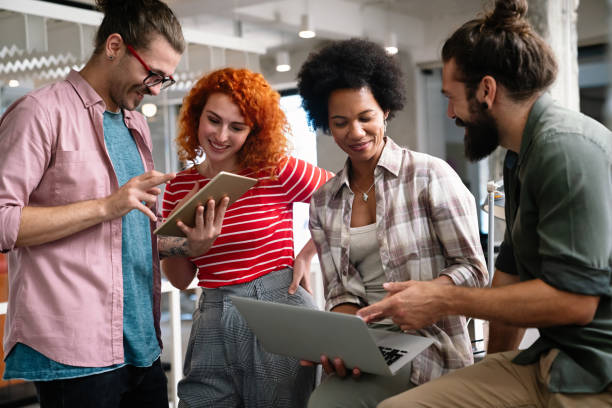 istock Smiling diverse colleagues gather in boardroom brainstorm discuss financial statistics together 1472260065