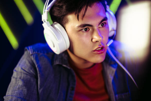 istock Tense video gamer looking at the computer screen as he plays a game with a headset on 1472261423