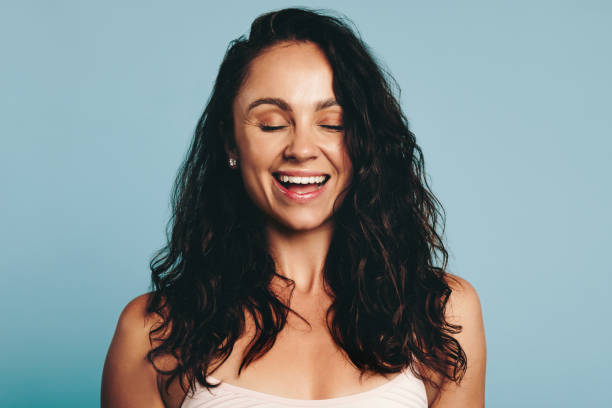 istock Self-confident young woman smiling in a studio 1472261635