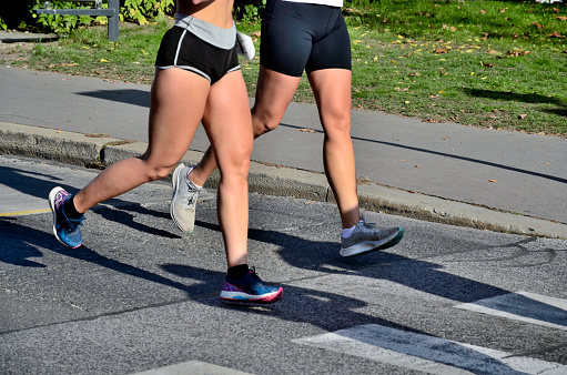 Lady and gent runners participating in a Marathon race, held on the streets of Budapest, Hungary.